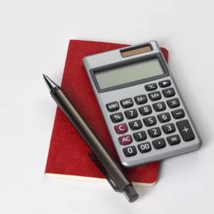 Picture of a calculator and pen.