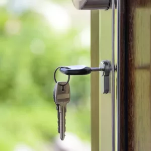 A door with a key in the lock.