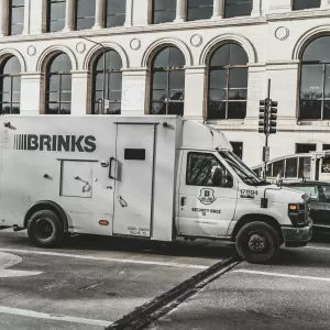 A Brinks armored security truck parked on a busy Chicago street, showcasing urban architecture.